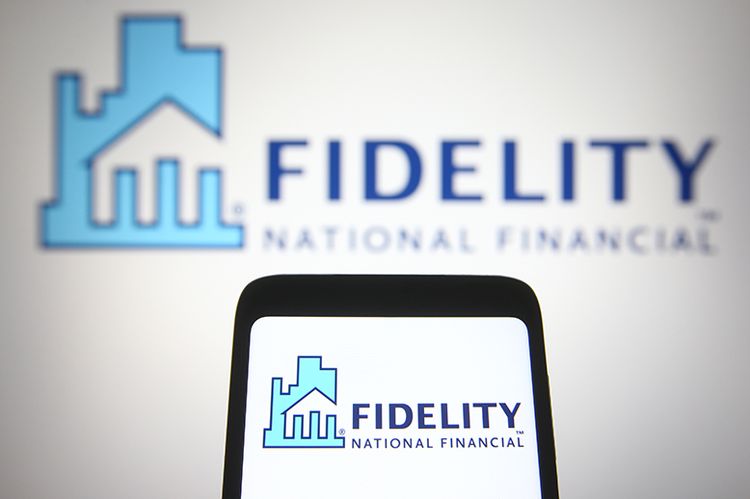 A Fidelity National Financial (FNF) logo is seen on a smartphone and a PC screen.