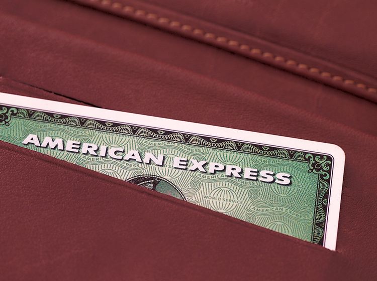 The top of an American Express Card is exposed in a leather wallet
